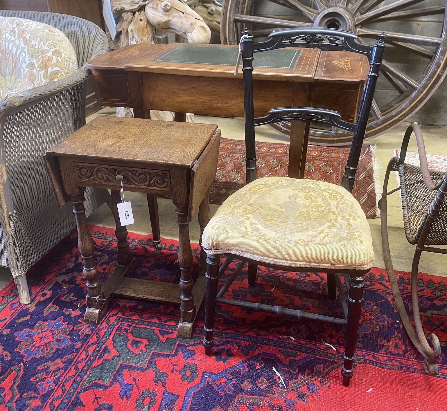 A Jacobean revival oak drop flap occasional table, width 41cm, depth 31cm, height 59cm and a Victorian ebonised side chair